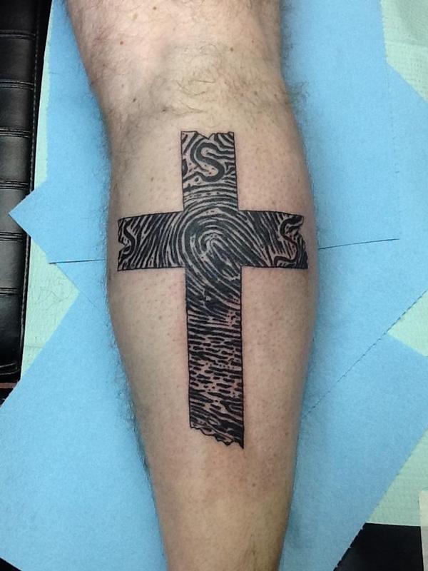 calf cross tattoo for women