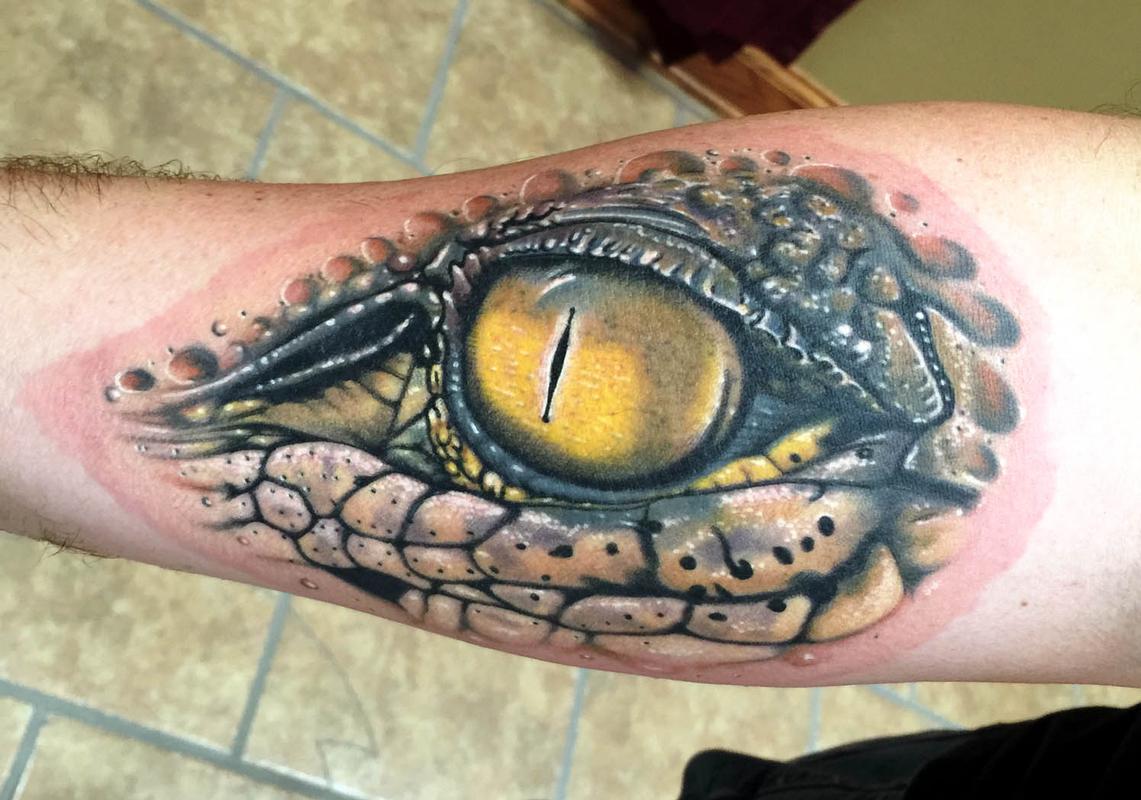 Microrealistic crocodile tattoo on the forearm