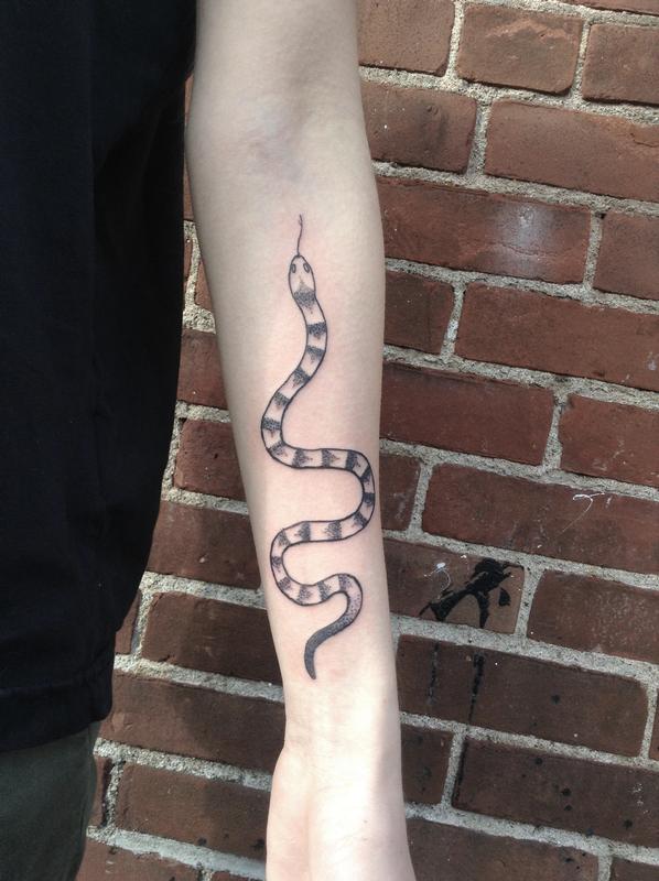 Snake tattoo on the left inner forearm