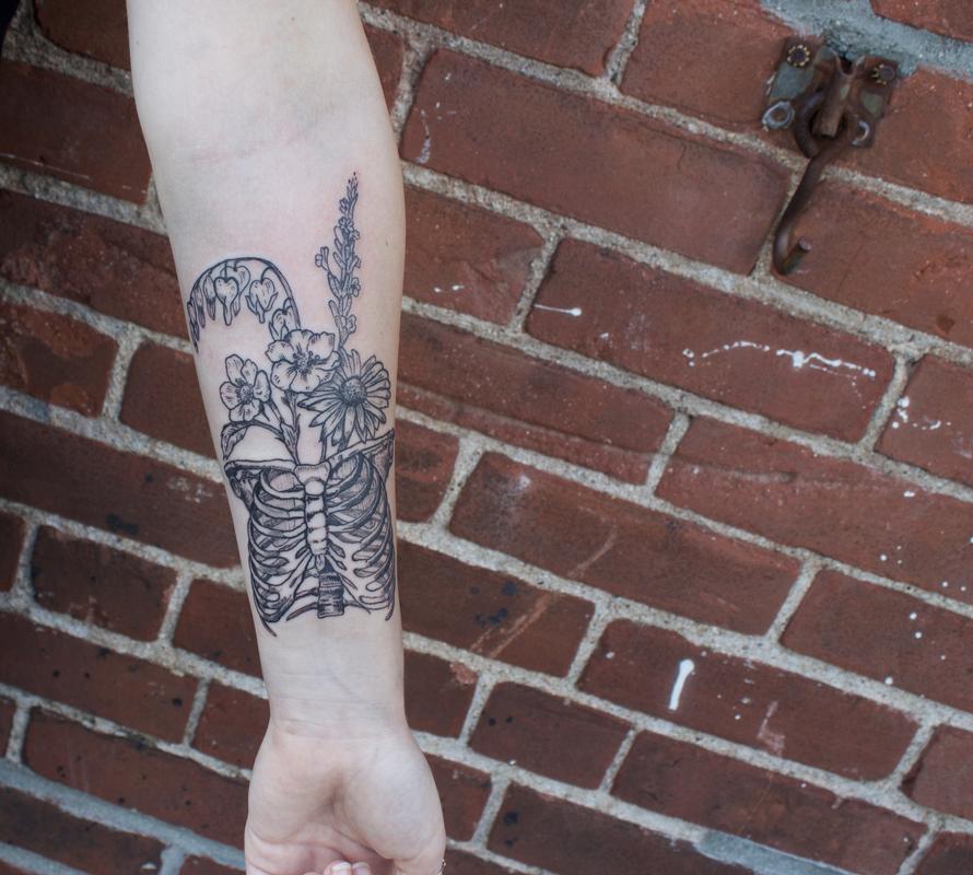 Black Illustrative Rib Cage With Wild Flowers Tattoo On Forearm By Ben 