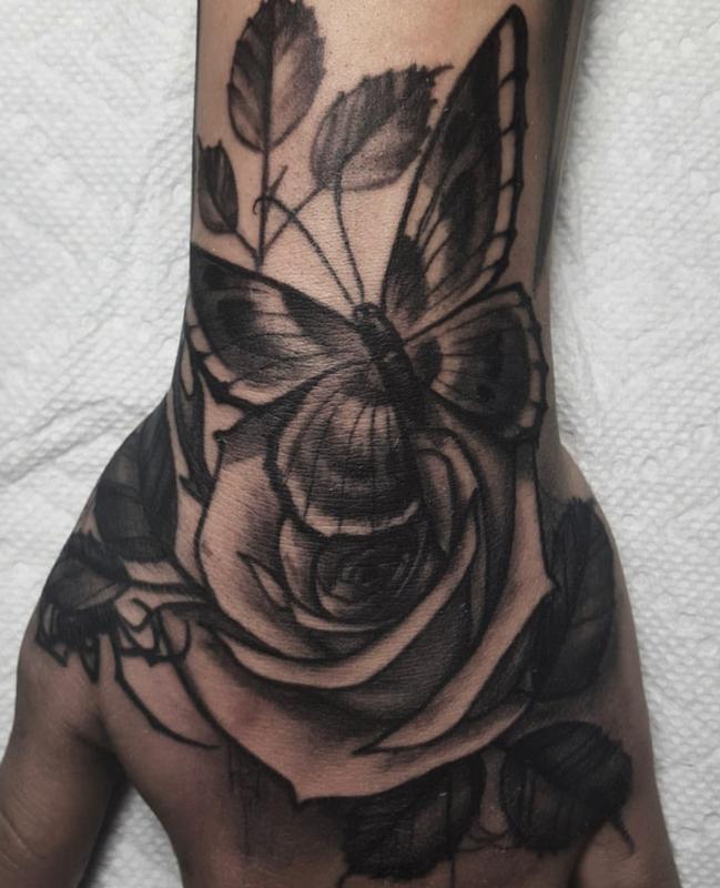 Rose and butterfly hand tattoo