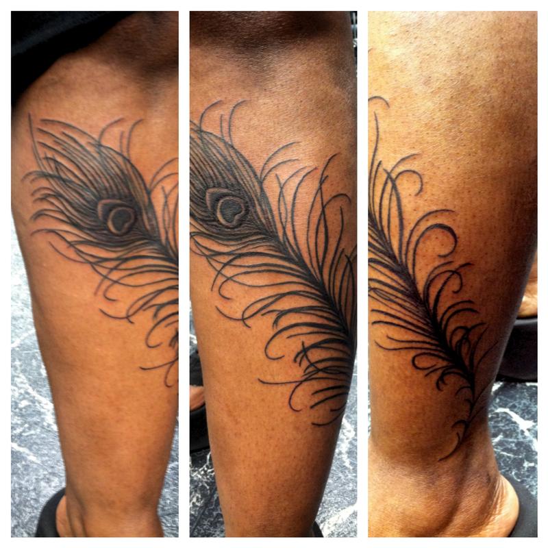 Peacock feather wrapped around the lower leg by Jen White: TattooNOW