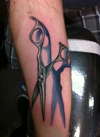 Comb and hairdressing scissors tattooed on the inner