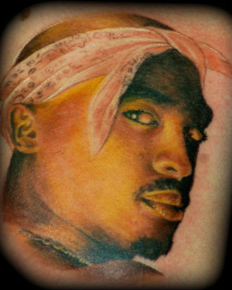Realistic style Tupac portrait tattoo located on the