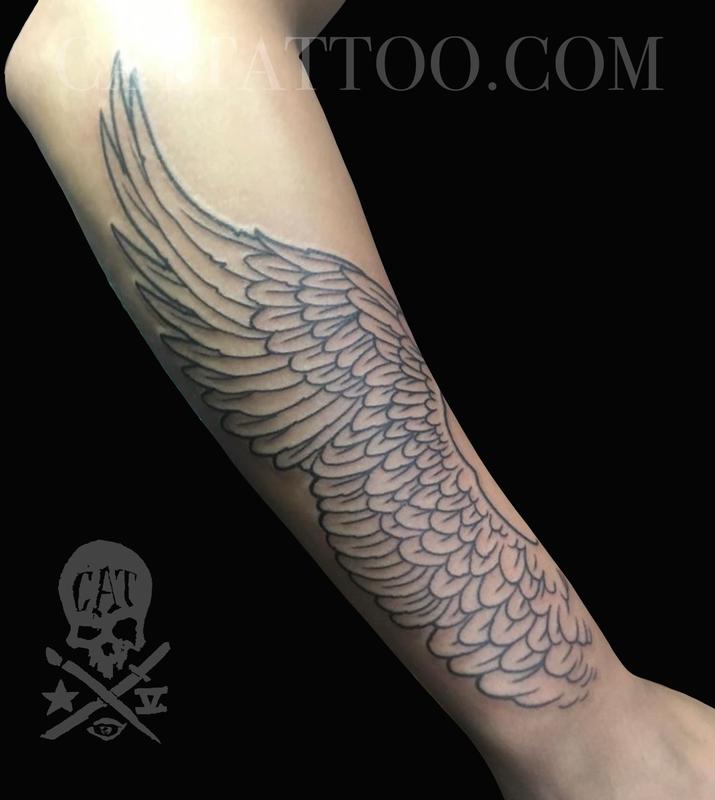 wing tattoo forearm