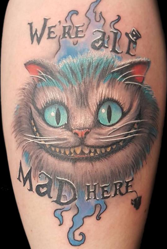 Black and grey Tim Burtons Cheshire Cat tattoo located