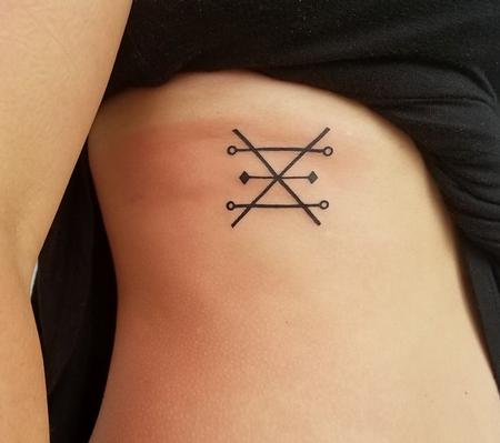 Stefanee Schofield - Symbol Tattoo on Ribs