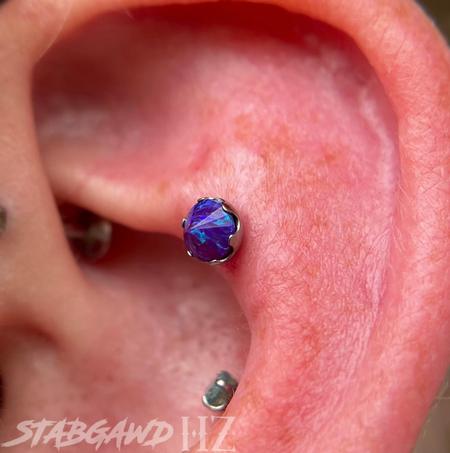Corey Godoy - Helix piercing with an inverted Opal! 