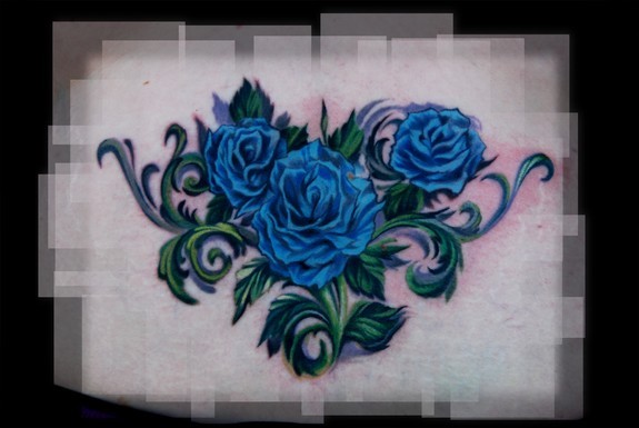 AI Image Generator Tattoo design that has 2 blue roses on the shoulder and  thorns coming out of it down the arm