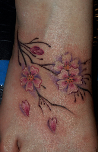 Cherry blossom tattoo located on the foot and ankle.
