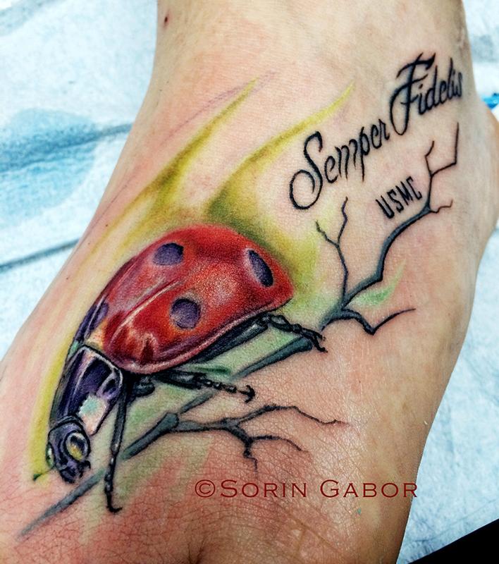 Realistic color ladybug foot tattoo by Sorin Gabor: TattooNOW