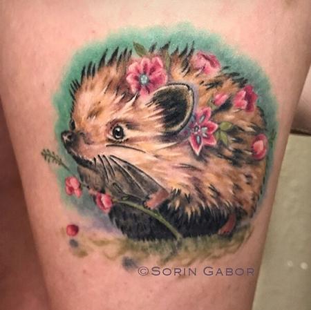 Sorin Gabor - whimsical realistic color feminine hedgehog tattoo with flowers