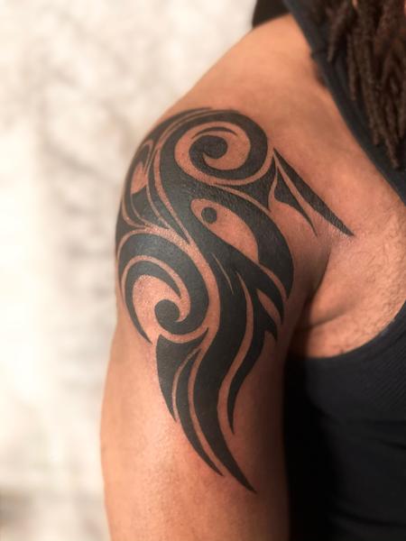 Tribal arm tattoo by Riley Muller at Unify Tattoo Company